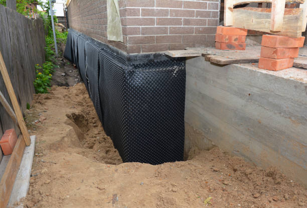 Happy homeowners after waterproofing job in Howe